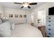 Inviting bedroom with hardwood floors, ceiling fan, and a glimpse of a luxurious adjacent bathroom at 2322 Poplar Springs Ne Dr, Brookhaven, GA 30319