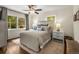 Cozy bedroom with hardwood floors, a ceiling fan, and natural light streaming through the windows at 2322 Poplar Springs Ne Dr, Brookhaven, GA 30319