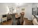 Dining room features a rustic table, upholstered chairs, and modern lighting fixtures at 2322 Poplar Springs Ne Dr, Brookhaven, GA 30319