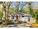 Charming brick home with a welcoming front porch and professionally landscaped front yard at 2322 Poplar Springs Ne Dr, Brookhaven, GA 30319