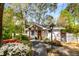 Charming brick home with a welcoming front porch and professionally landscaped front yard at 2322 Poplar Springs Ne Dr, Brookhaven, GA 30319