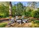 Backyard fire pit with chairs and tiki torches for outdoor entertaining in a lush and private setting at 2322 Poplar Springs Ne Dr, Brookhaven, GA 30319
