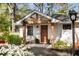 Charming brick home with a welcoming front porch featuring a swing and well-manicured landscaping at 2322 Poplar Springs Ne Dr, Brookhaven, GA 30319