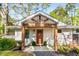Inviting front porch featuring swing seating and a natural wood door and supports at 2322 Poplar Springs Ne Dr, Brookhaven, GA 30319