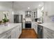 Modern kitchen with stainless steel appliances, white cabinets, hardwood flooring, and an island at 2322 Poplar Springs Ne Dr, Brookhaven, GA 30319