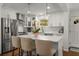 Bright kitchen features a large island with seating, stainless steel appliances, and white cabinetry at 2322 Poplar Springs Ne Dr, Brookhaven, GA 30319