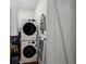Efficient laundry room featuring stacked washer and dryer units, maximizing space and convenience at 2322 Poplar Springs Ne Dr, Brookhaven, GA 30319