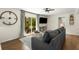 Cozy living room with a large sofa, sliding glass doors, and a view of the backyard at 2322 Poplar Springs Ne Dr, Brookhaven, GA 30319