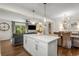 Open concept living area with kitchen island, living room, and dining area with modern furnishings at 2322 Poplar Springs Ne Dr, Brookhaven, GA 30319