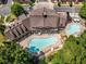 Overhead view of a community pool and clubhouse with sun loungers and manicured landscaping at 402 River Vista Dr, Atlanta, GA 30339