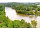 An aerial view showing the property's river frontage with lush trees at 402 River Vista Dr, Atlanta, GA 30339