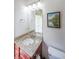 Powder room featuring granite counters, framed mirror, and a commode at 402 River Vista Dr, Atlanta, GA 30339