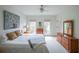 Sunlit bedroom with white walls, carpeted floor, ceiling fan, and natural light at 402 River Vista Dr, Atlanta, GA 30339