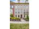 Charming three-story townhouse featuring a beautifully landscaped front yard at 402 River Vista Dr, Atlanta, GA 30339