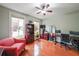 Home office with wood floors, dual monitors, bookcases, and natural light at 402 River Vista Dr, Atlanta, GA 30339