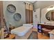 A bright, neutral spa room with a massage table, decor baskets, and a lovely sink and mirror at 402 River Vista Dr, Atlanta, GA 30339