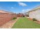 Backyard featuring a well-manicured lawn and a full brick privacy fence at 1170 Livery Cir, Lawrenceville, GA 30046