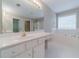 Primary bathroom with double sink vanity, soaking tub, and a large mirror at 1170 Livery Cir, Lawrenceville, GA 30046