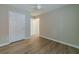A bedroom with neutral walls, light trim, wood flooring, and a ceiling fan at 1170 Livery Cir, Lawrenceville, GA 30046