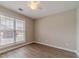 Cozy bedroom features wood floors, natural light from the window, and neutral color palette at 1170 Livery Cir, Lawrenceville, GA 30046
