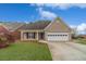 Charming brick home featuring an attached garage and well-maintained front lawn at 1170 Livery Cir, Lawrenceville, GA 30046