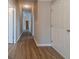 Hallway with neutral paint and wood-look flooring leading to bedrooms and living areas at 1170 Livery Cir, Lawrenceville, GA 30046