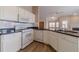 Bright white kitchen with granite countertops and appliances, flowing into the living space at 1170 Livery Cir, Lawrenceville, GA 30046