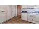 Kitchen featuring a gas range, white cabinets and wood flooring at 1170 Livery Cir, Lawrenceville, GA 30046