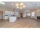Open-concept space combining kitchen, dining, and living areas, with wood floors and fireplace at 1170 Livery Cir, Lawrenceville, GA 30046