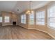 Open-concept living room featuring large windows, fireplace and wood flooring at 1170 Livery Cir, Lawrenceville, GA 30046