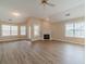 Bright living room featuring large windows, a fireplace, and wood-look flooring at 1170 Livery Cir, Lawrenceville, GA 30046