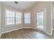 Bright living room features wood floors, two windows, and a door to the exterior at 1170 Livery Cir, Lawrenceville, GA 30046