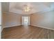 The main bedroom is spacious with wood floors, trey ceiling, and neutral paint at 1170 Livery Cir, Lawrenceville, GA 30046