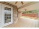 This is a brick patio with a white door that leads into the backyard and a ceiling fan at 1170 Livery Cir, Lawrenceville, GA 30046