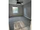 Neutral bedroom featuring natural light, a ceiling fan and gray carpet at 136 Rue Fontaine, Lithonia, GA 30038