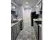 Galley kitchen with appliances, neutral tile floors, and cabinetry at 136 Rue Fontaine, Lithonia, GA 30038