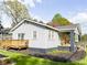 Charming home featuring a wooden deck and a cozy front porch with a swing, perfect for outdoor enjoyment at 1735 Spring Ave, East Point, GA 30344