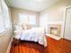 Bright bedroom with hardwood floors, fireplace, and ample natural light, creating a cozy and inviting atmosphere at 1735 Spring Ave, East Point, GA 30344