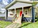 Inviting front porch with swing and bright red front door, perfect for relaxing outdoors at 1735 Spring Ave, East Point, GA 30344