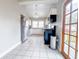 Well-lit kitchen with stainless steel appliances, white cabinets, and tile flooring, perfect for cooking and entertaining at 1735 Spring Ave, East Point, GA 30344