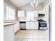 Bright kitchen featuring stainless steel appliances, white cabinetry, and tile floors, ready for culinary adventures at 1735 Spring Ave, East Point, GA 30344