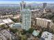 An aerial view of a high rise condo building featuring a pool, tennis court, and parking at 2870 Pharr Court South Nw # 1209, Atlanta, GA 30305