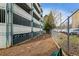 View of fenced dog run with wood chip ground cover near the parking garage, offering convenience for pet owners at 2870 Pharr Court South Nw # 1209, Atlanta, GA 30305