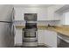 Well-equipped kitchen with stainless steel refrigerator and modern appliances at 2870 Pharr Court South Nw # 1209, Atlanta, GA 30305