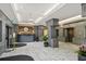 A condo lobby featuring marble floors, chandeliers, a concierge desk, and elevators at 2870 Pharr Court South Nw # 1209, Atlanta, GA 30305
