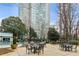 Outdoor pool area with comfortable seating and a view of the building, set amid trees and well-maintained landscaping at 2870 Pharr Court South Nw # 1209, Atlanta, GA 30305