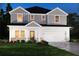 Charming two-story home with white and gray siding, a welcoming front porch, and a manicured lawn at 365 Denali Butte Ter, Canton, GA 30114