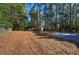 Large backyard with mature trees and a new concrete patio at 380 Inman Rd, Fayetteville, GA 30215