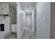 Hallway with wood-look floors featuring a brick fireplace and white trim at 380 Inman Rd, Fayetteville, GA 30215