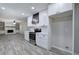 Modern kitchen featuring white cabinets, subway tile backsplash, stainless steel appliances and wood-look floors at 380 Inman Rd, Fayetteville, GA 30215